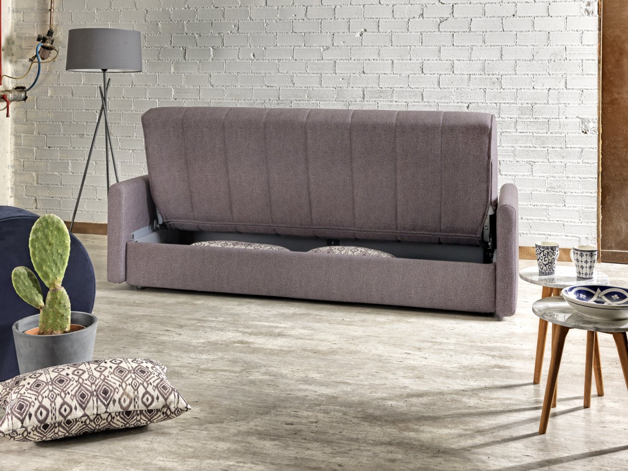 Four seater sofa bed with storage compartment that turns into a double bed while it opens.