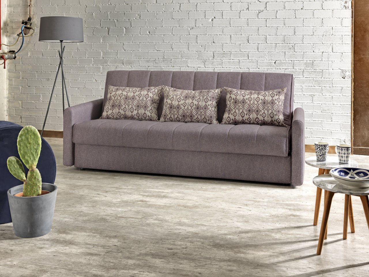 Four seater sofa bed with storage compartment that turns into a double bed, closed as a sofa.